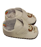 White Baby Shoes With a Cartoon Lion Appliqué